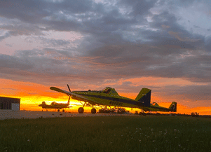 Yellow Agricultural Aircraft Against a Beautiful Nighttime Sky