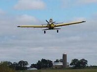 Yellow Agricultural Aircraft Flying in the Sky